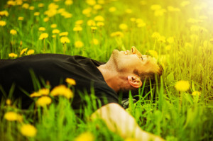 man lying on grass at sunny day